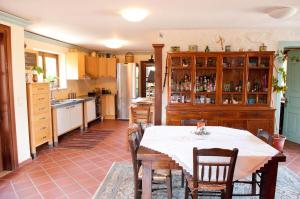 a kitchen with a table and chairs in a room at Traditional Stone Villa, Spacious Seaside Retreat in Lióta +10 photos