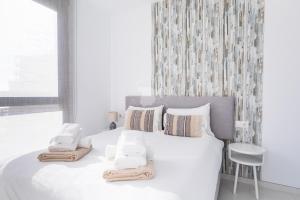 biała sypialnia z dużym białym łóżkiem z poduszkami w obiekcie CostaBlancaDreams Calpe Beach 2 6O in Calpe w mieście Calpe +35 zdjęć