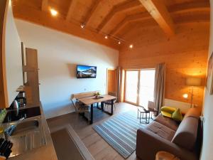 a living room with a couch and a table at Bio & Reiterhof der Veitenhof - Pferde, Berge, Wellness & Freiheit im Ötztal in Niederthai