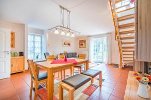 a kitchen and dining room with a table and chairs at Piratenkajüte-B66 in Dranske