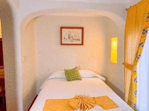 チョルーラにあるVillas Arqueologicas Cholulaのベッドルーム1室(弓の付いたベッド1台付) +32枚の写真