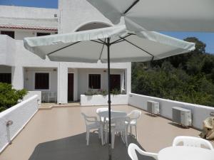 a patio with a table and chairs and an umbrella at Aeolos Hotel Apartments in Gythio