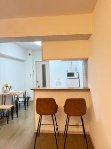 two chairs sitting at a counter in a room at Camelot House in Fukuoka +17 photos