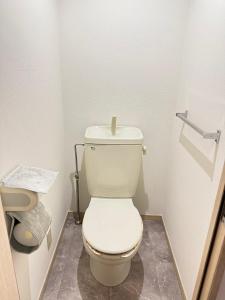 a bathroom with a toilet with a candle on it at Camelot House in Fukuoka