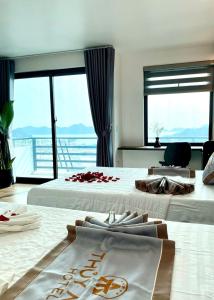 a hotel room with two beds with towels on them at Thuỷ Anh Hotel in Cat Ba