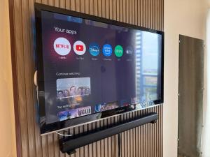 a flat screen tv hanging on a wall at Cozy Space in the City in Cagayan de Oro