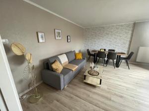 a living room with a couch and a table at Evry Moon Apartment 70m2 Spacious and bright in Courcouronnes