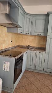 a kitchen with white cabinets and a sink at Marana apartments with private beach in Santa Marinella +54 photos