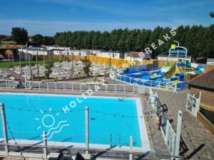 a large swimming pool with a water park at Valeria - Gold 3 bedroom with Garden and Parking - Seal Bay in Selsey