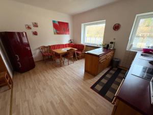 a kitchen and living room with a table and a couch at FeWo II Glücksmomente Bostalsee in Nohfelden