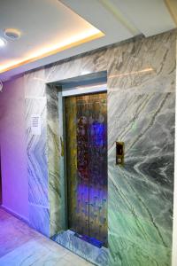a door in a room with a marble wall at Hôtel Jawharat El Jadida in El Jadida +18 photos
