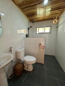 a bathroom with a toilet and a sink at The River Huts in Nongkhiaw