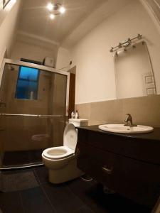 a bathroom with a toilet and a sink at Ceylon luxury Apartments in Maharagama