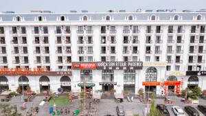 a large white building with a street in front of it at ATOUR Phoenix Hotel in Bắc Ninh
