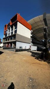 a person taking a picture of a building at Hotel Shree Hari Om Residency in Ahmedabad +4 photos