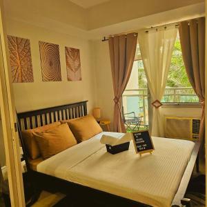 a bedroom with a bed with a sign on it at Azure Urban Resort Staycation in Manila