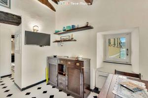 a living room with a tv on the wall at Arbanella Sea View, Terre Marine in Vernazza