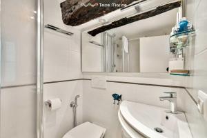 a bathroom with a toilet and a sink and a mirror at Arbanella Sea View, Terre Marine in Vernazza +5 photos