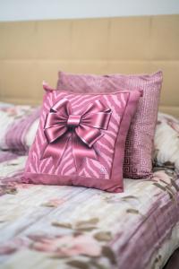 a pink pillow with a bow on top of a bed at Casa mario in Piedimonte San Germano +52 photos