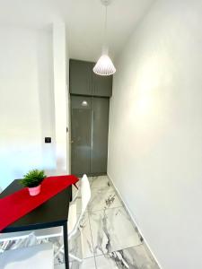 a dining room with a red table and white chairs at Eva's Apartments with great view in Pálioura +13 photos