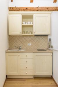 a kitchen with white cabinets and a sink at Dubrovnik Finest Apartments in Dubrovnik