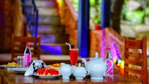 a table with plates of food and drinks on it at Dambulla Village Hotel in Dambulla