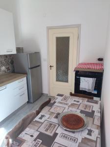 a kitchen with a table with a pizza on it at Casa del Celo in Rapallo +11 photos