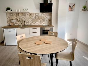 a kitchen with a wooden table with two cookies on it at Cos pés en Palas in Palas de Rei