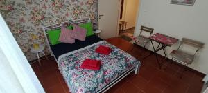 a bedroom with a bed with red pillows on it at Floral Tribute Studio in Kavála