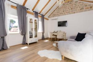 a living room with a couch and a table at Dubrovnik Finest Apartments in Dubrovnik