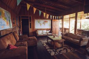 a living room with a couch and a table at Spanish by the River - Turrialba in Turrialba