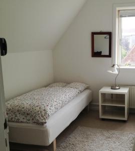 a bedroom with a bed and a mirror and a window at Kleiters Bed & Kitchen in Copenhagen
