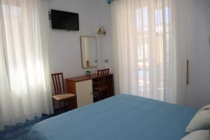 A bed or beds in a room at Meublè Casa Mannini Rooms
