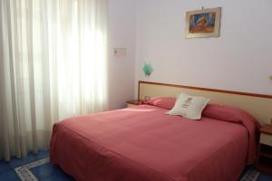 A bed or beds in a room at Meublè Casa Mannini Rooms