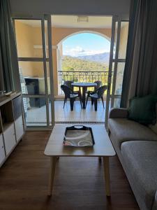 a living room with a couch and a table at Appartement 4 personnes Cap Estérel centre du village in Saint-Raphaël +26 photos