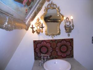 a bathroom with a sink and a mirror on the wall at Ferme de la Dorvallière in Cavagnac