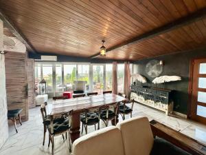 a dining room with a large wooden table and chairs at Boutique home the beach in Malgrat de Mar