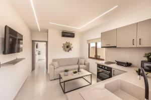a living room with a couch and a table at SEVIS SUITES in Ayia Napa