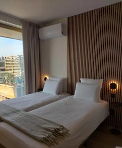 Postel nebo postele na pokoji v ubytování Hotel Essenza