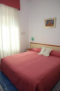 A bed or beds in a room at Meublè Casa Mannini Rooms