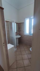 a bathroom with a toilet and a sink at ViLLA GASPARE FRONTE MARE in Favignana
