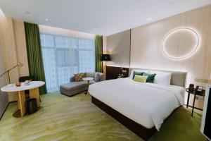 Postelja oz. postelje v sobi nastanitve Wuhan Hazens Hotel