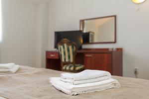 a pile of towels sitting on top of a table at Hotel CENTRAL Balchik in Balchik
