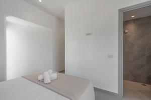 a bedroom with a bed with two towels on it at Green & Purple in Khlóï +31 photos