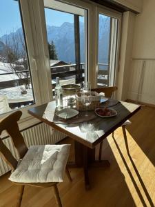 a dining room table with a view of the mountains at Studio Heaven in Grächen