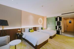 Postelja oz. postelje v sobi nastanitve Wuhan Hazens Hotel