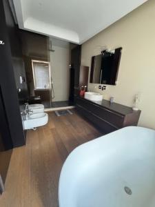 a large bathroom with a toilet and a sink at Suite con terrazza in centro storico in Catania