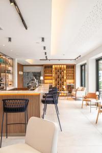 a tasting room with a bar and chairs at Doria Park Hotel in Lerici
