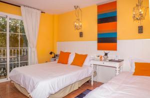 Postel nebo postele na pokoji v ubytování Boutique Hotel Pueblo