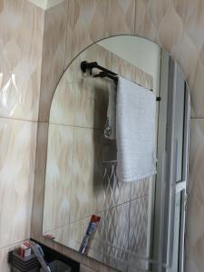 a bathroom with a mirror and a towel at Mach Hotel in Dar es Salaam +28 photos